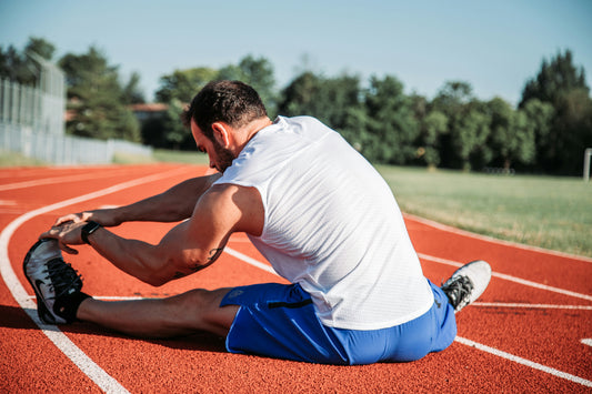 Man Stretching on Race Track